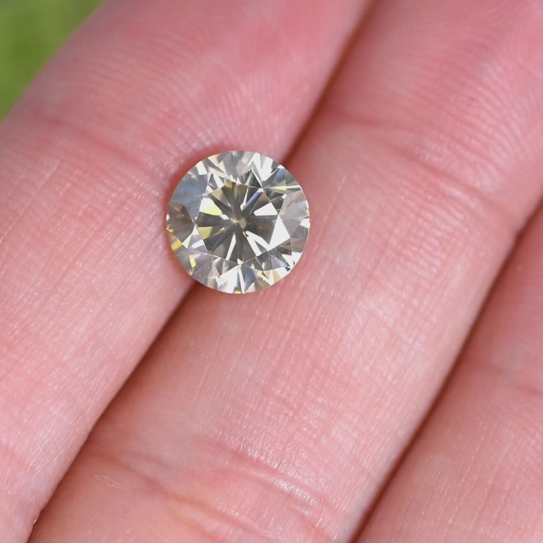 Rotating loose 2.25 carat fancy yellow brown diamond showing brilliance, clarity, and champagne tones in motion.