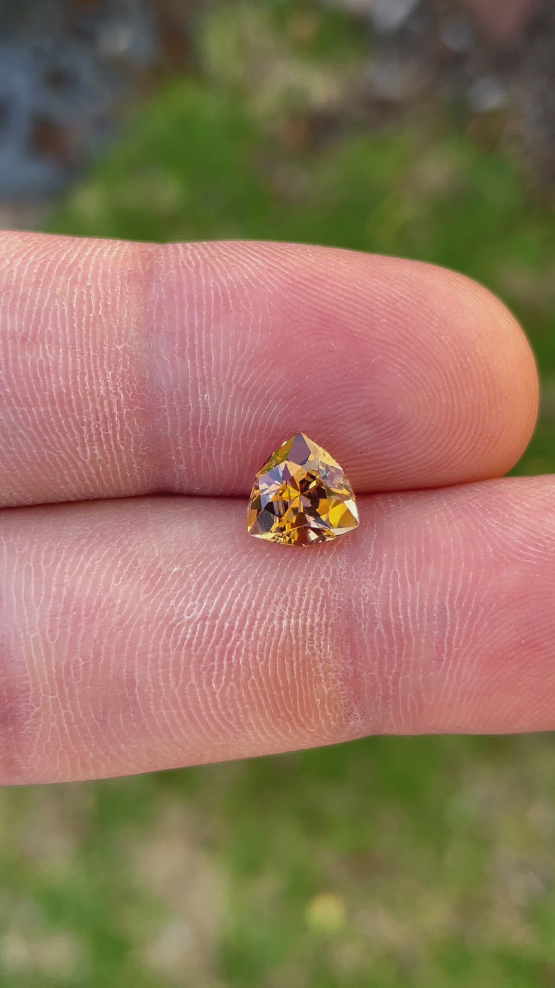 Video of a Custom Trilliant Cut Tanzanite Gemstone in Vivid Peach Orange Color, Weighing 2.01 Carats, with Dimensions 8.06 x 8.14 x 5.32 mm, Originating from Merelani Hills, Arusha Region, Tanzania - No Treatment
