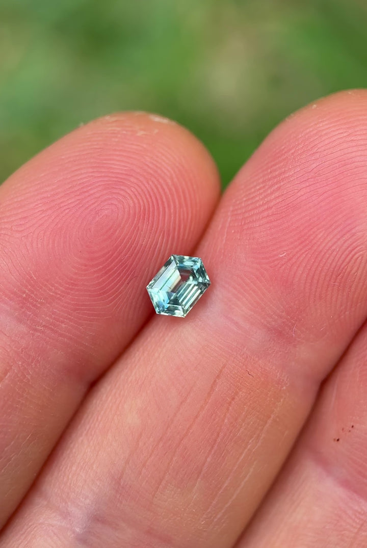 Rotating video of untreated Montana sapphire with vivid parti color, showing sharp step facets in hexagon shape