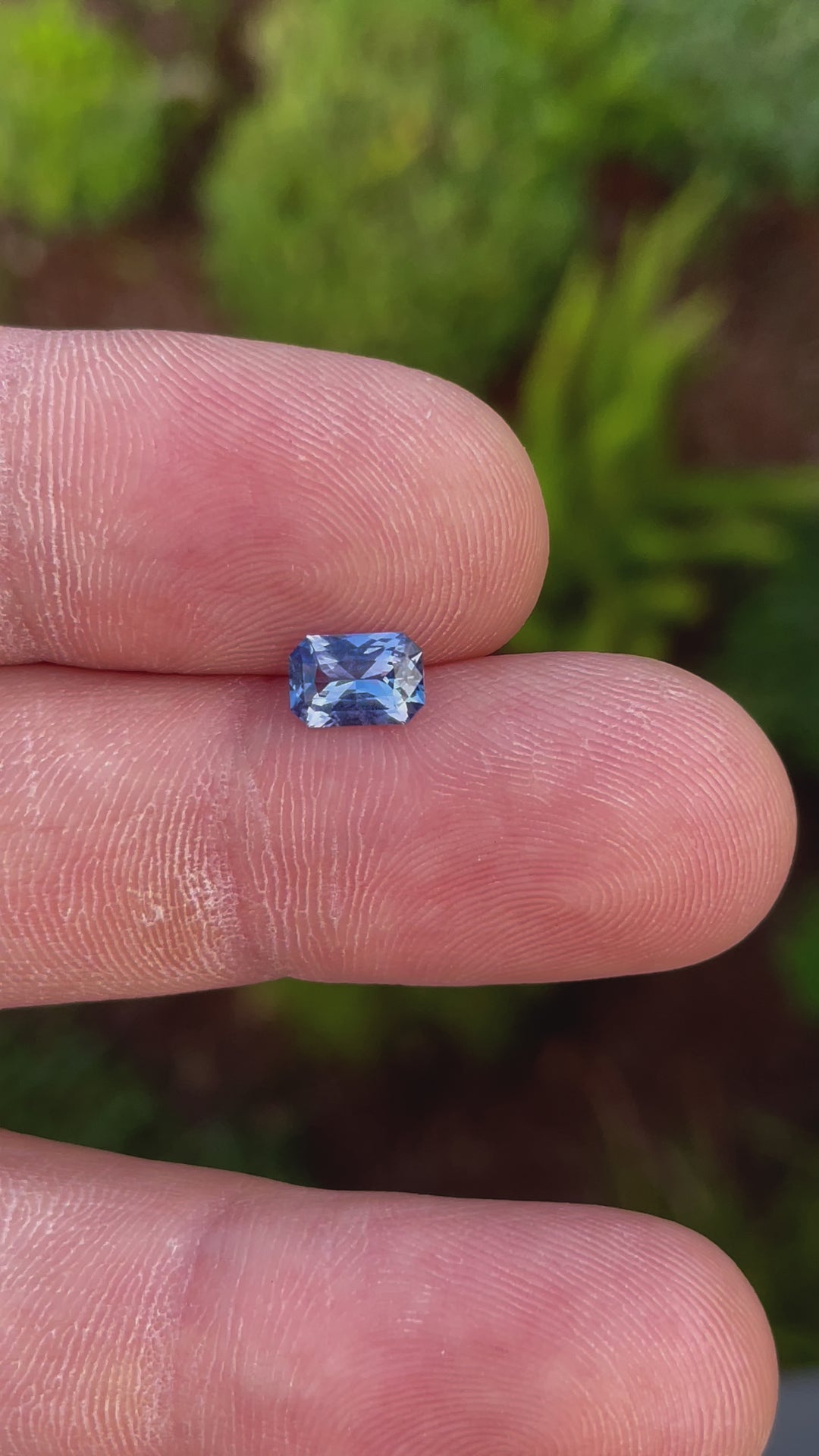360-degree video of a 1.10 carat radiant cut sapphire gemstone, highlighting its vibrant blue and lavender tones, untreated and sourced from Sri Lanka