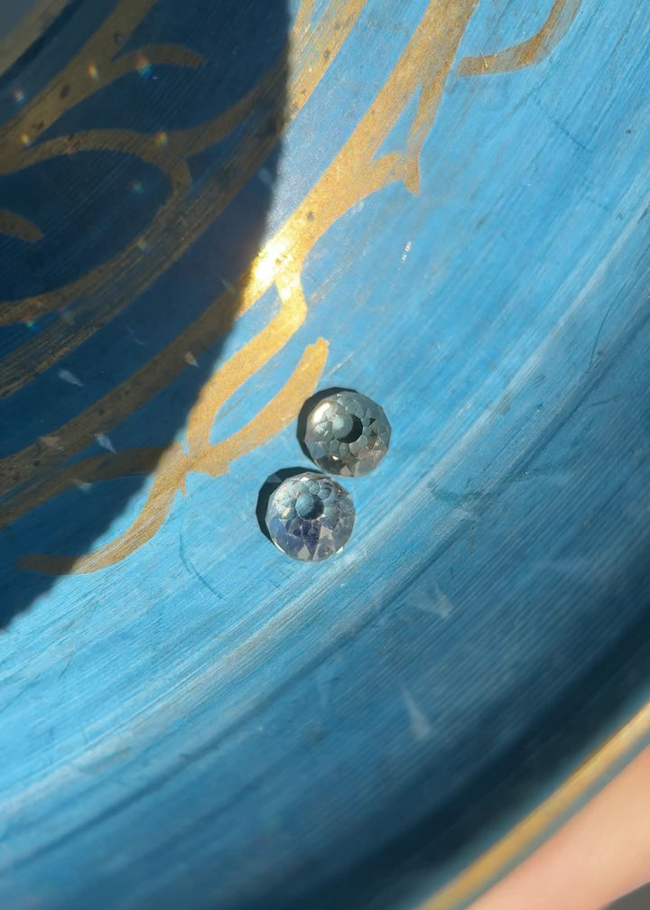 Video of a matched 1.11CT Mughal cut diamond pair in Fancy Light Brown C3 being rotated to show brilliance, VVS clarity, and medium blue and yellow fluorescence from natural South African stones.