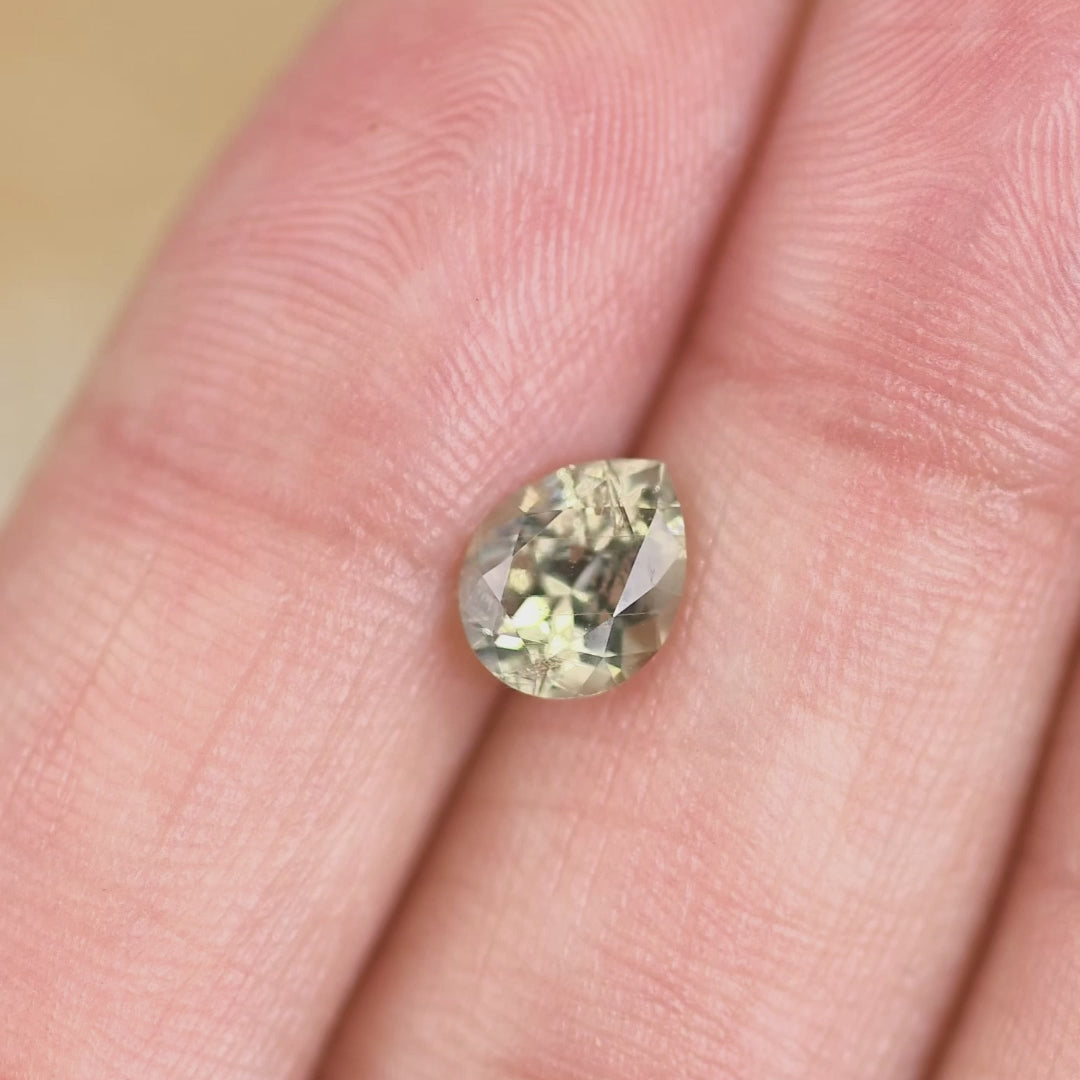 Close-up video of a light teal Montana sapphire moved by hand, demonstrating brilliance, facet reflections, and natural untreated sapphire clarity.