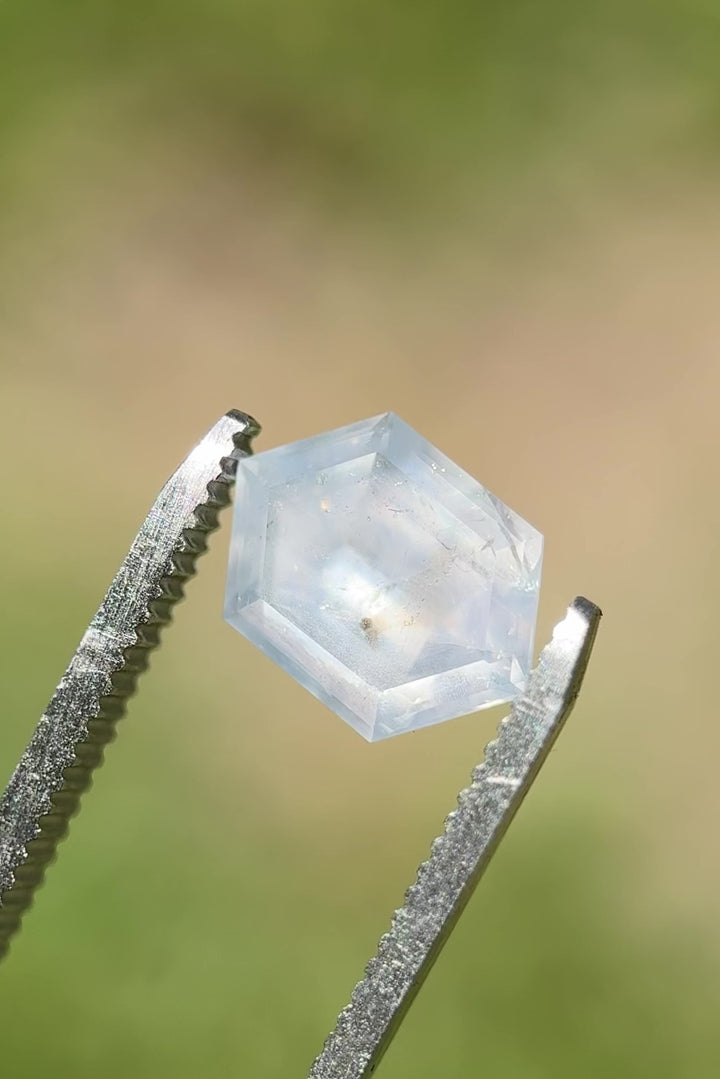Video of a 4.34ct color-changing hexagon sapphire from Montana showing soft transitions between gray, blue, and lavender under natural light