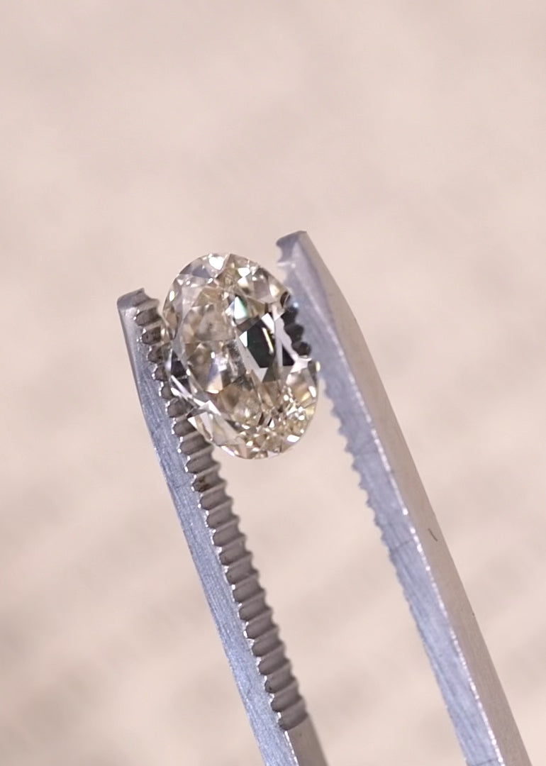 Oval diamond displaying strong blue fluorescence under UV light highlighting unique optical properties.