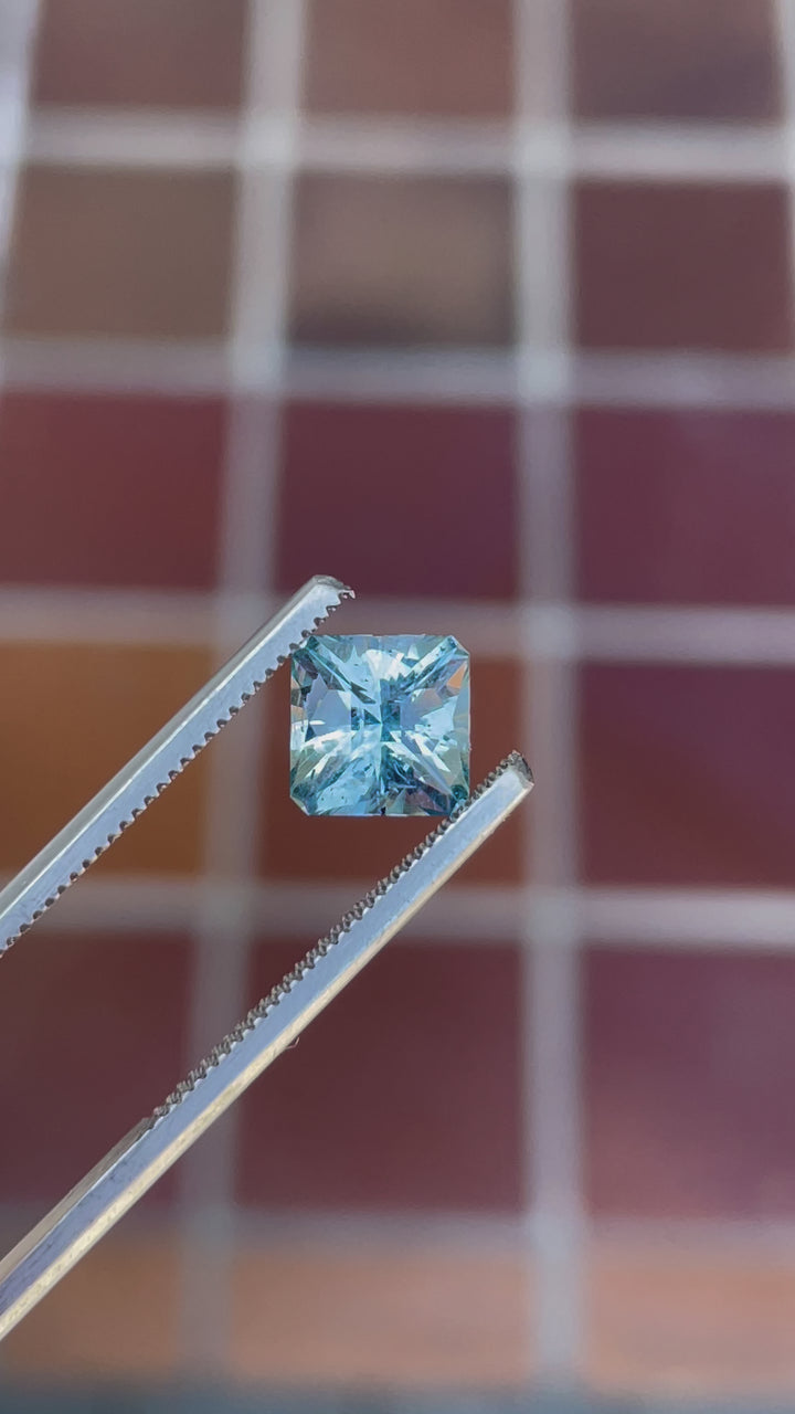 Video showcasing the vibrant blue and teal Sapphire from El Dorado Bar Deposit, Montana. This 2.49-carat gem displays its exquisite Cushion cut under varying light.