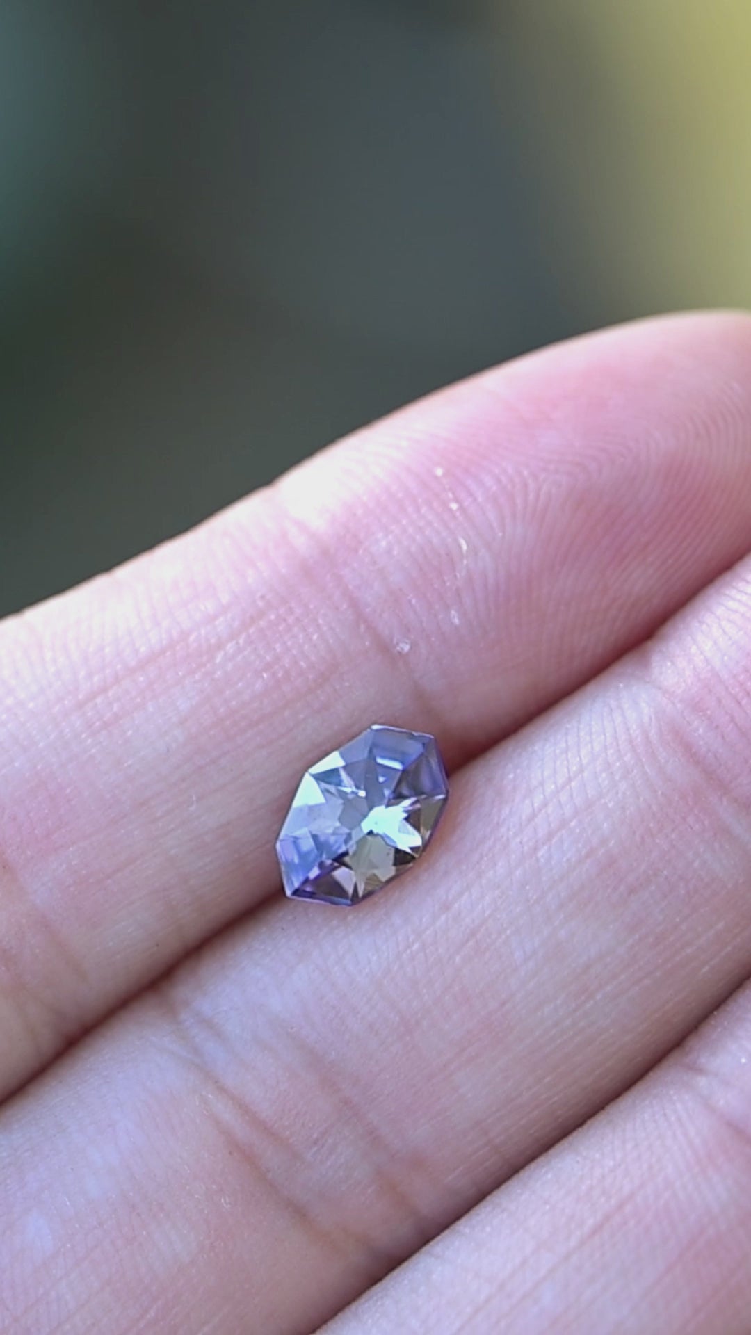 Experience the remarkable pleochroism of this custom-cut 1.11 carat tanzanite as changing light reveals elegant flashes of violet, steel gray, teal, and blue.