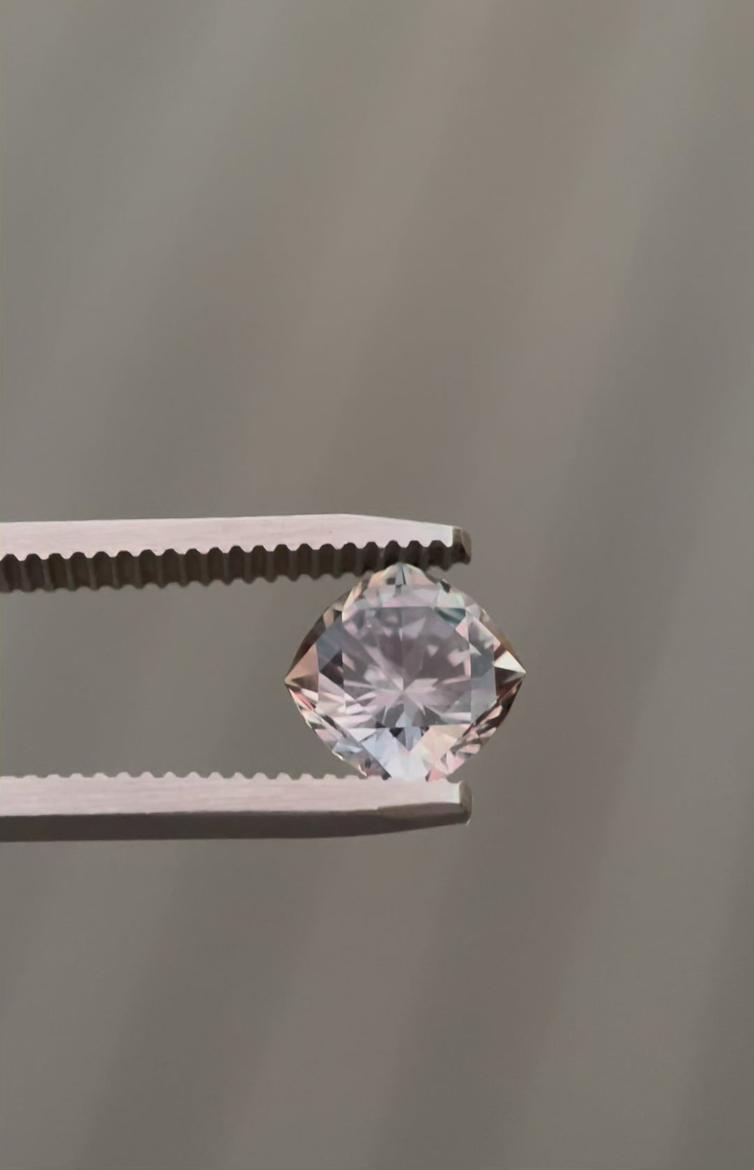 Video of a 3.13-carat color-change sapphire under fluorescent light, revealing its unique hues of grayish-green and pinkish-purple.