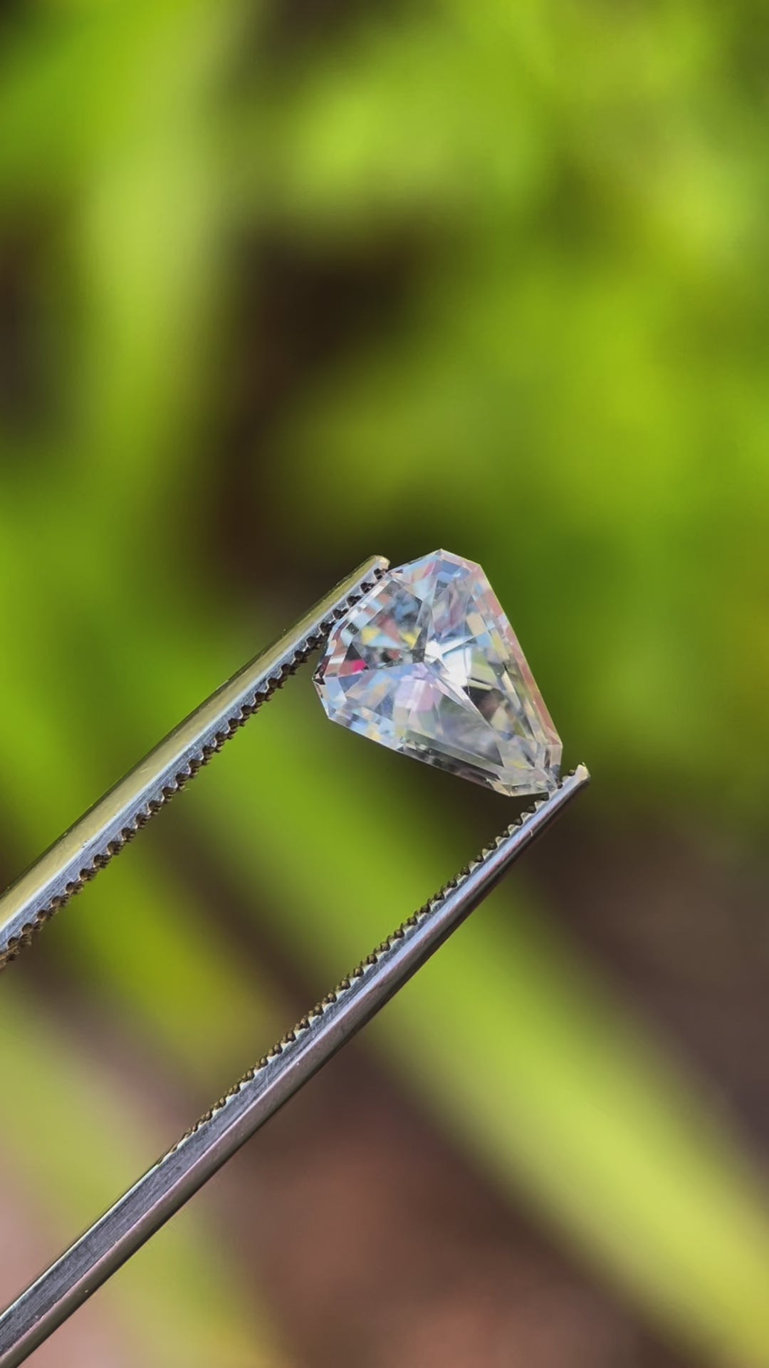 Close-up video of Custom Shield Cut Sapphire, Light Ceylon Gray Blue, 1.98 Carats, 9.92 x 7.81 x 3.96 mm, Sourced from Sri Lanka, No Heat Treatment, $1980.00 Price