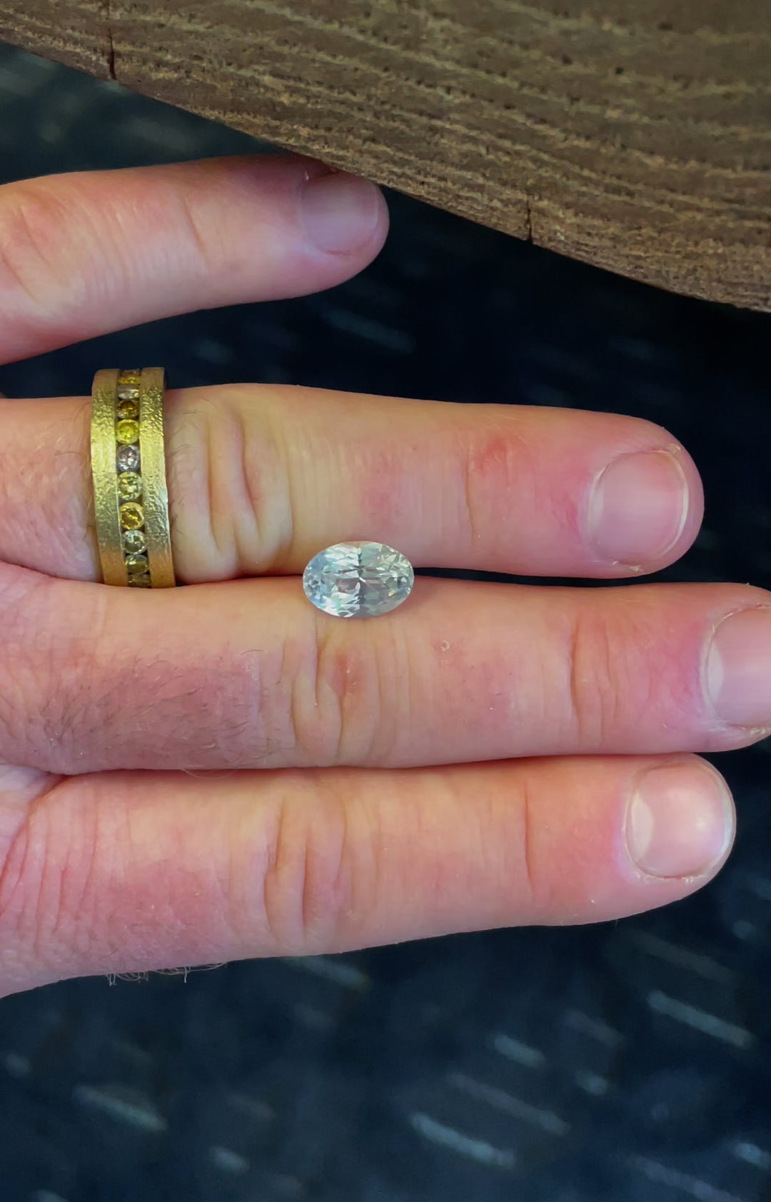 A detailed showcase of a 4.23-carat opalescent white sapphire as it moves under light, emphasizing its brilliance and natural facets.