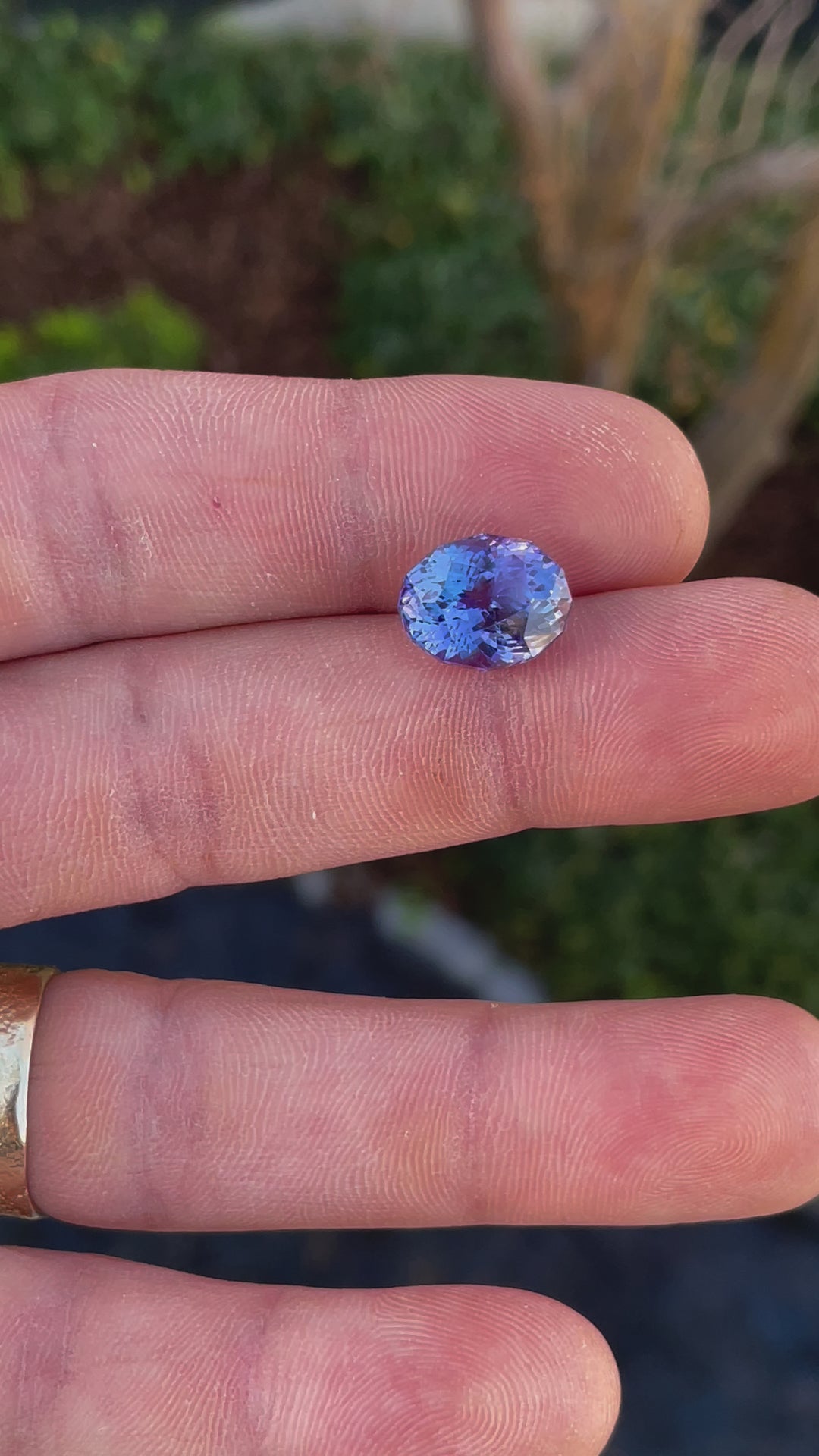 A video showcasing the brilliance of a 9.31-carat tanzanite gemstone, emphasizing its custom mix oval cut and rich blue-purple tones.