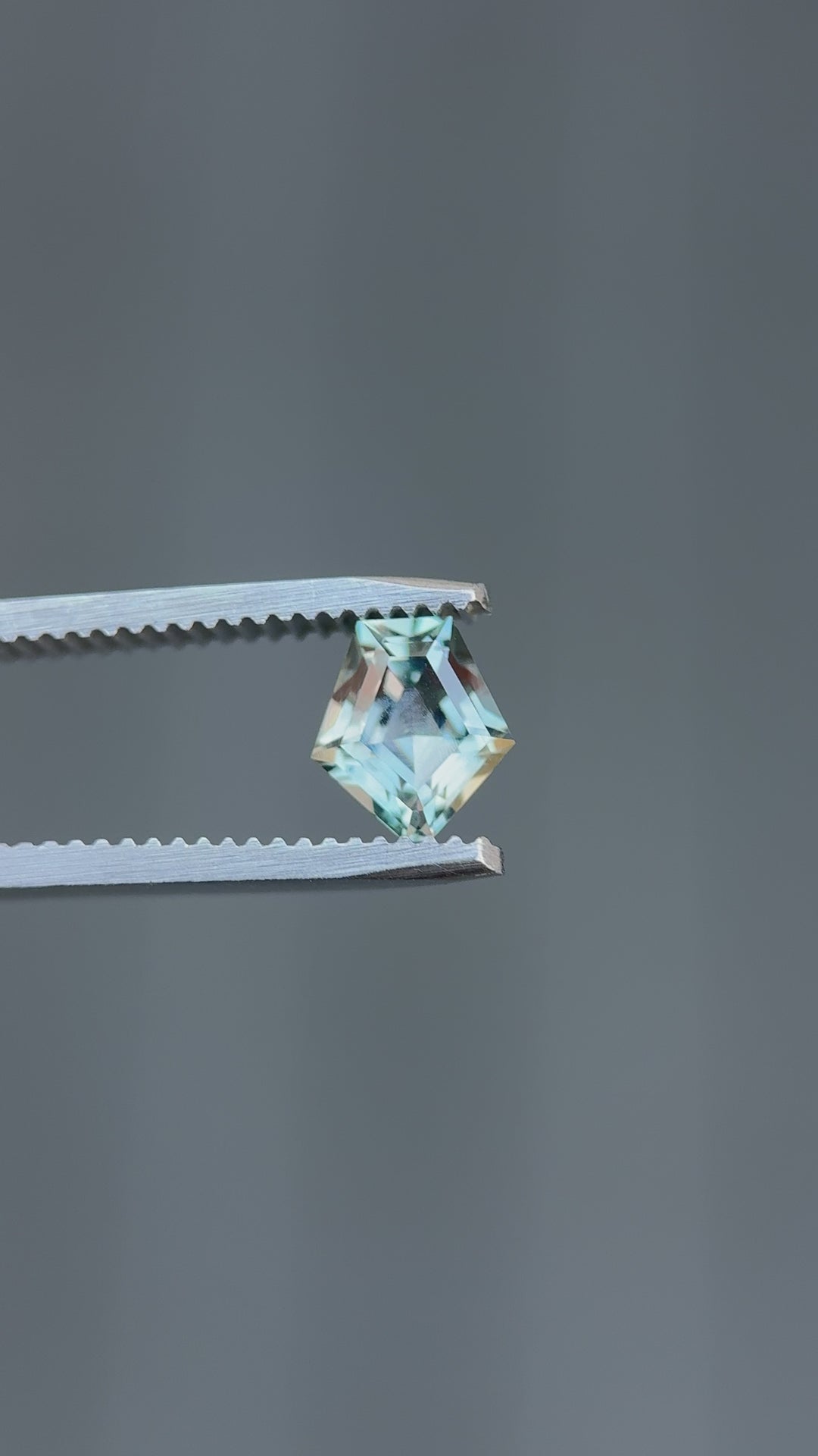 High-resolution video of heated Montana sapphire showcasing color change from teal blue to grey purple