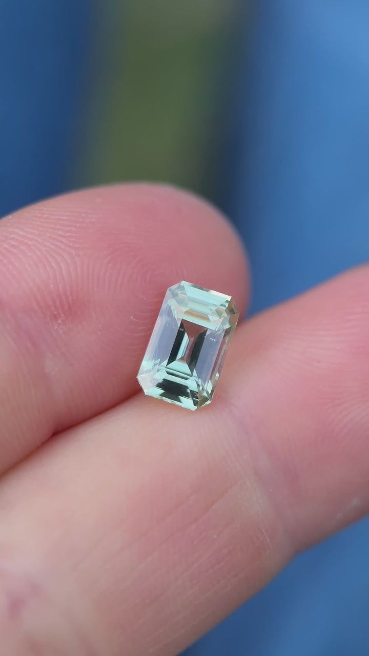 2.52ct mint green sapphire rotating in hand, revealing bright green flashes and excellent brilliance.