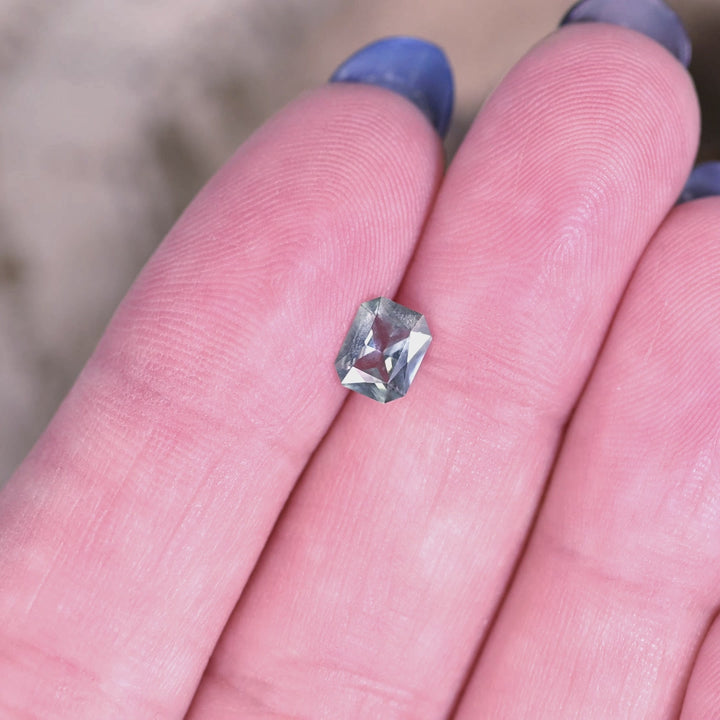 Close-up rotating video of 0.71 carat unheated Montana sapphire, teal green blue tones shifting in natural light with radiant mix cut faceting