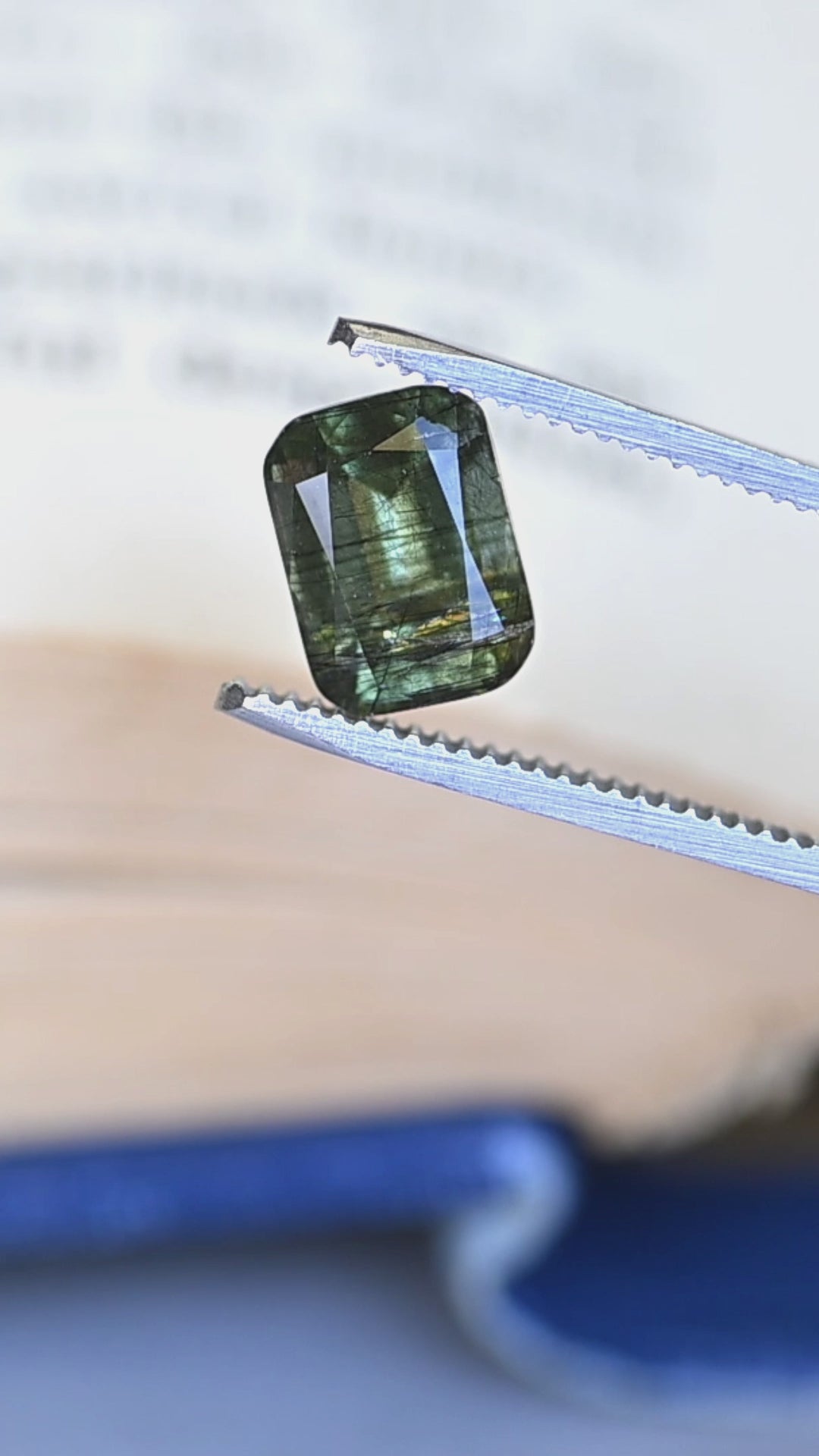 Watch this untreated 4.35 carat Pakistan peridot rotate in natural light, revealing its soft forest green color, custom cushion mix cut, and distinctive natural needle inclusions.