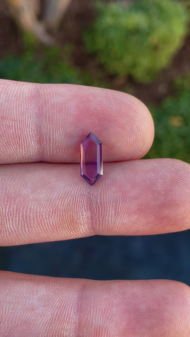 Video showcasing a 1.81 carat hexagonal step cut spinel gemstone with purple-pink hues, untreated and sourced from Sri Lanka.