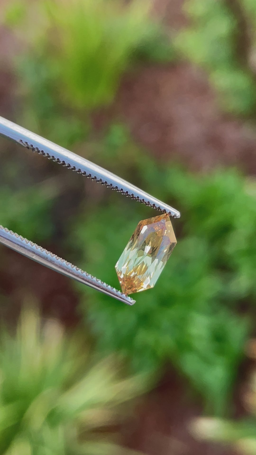 A video of a 2.01-carat canary yellow sapphire viewed in natural lighting. The modified hexagon cut enhances the gemstone's brilliance and clarity.