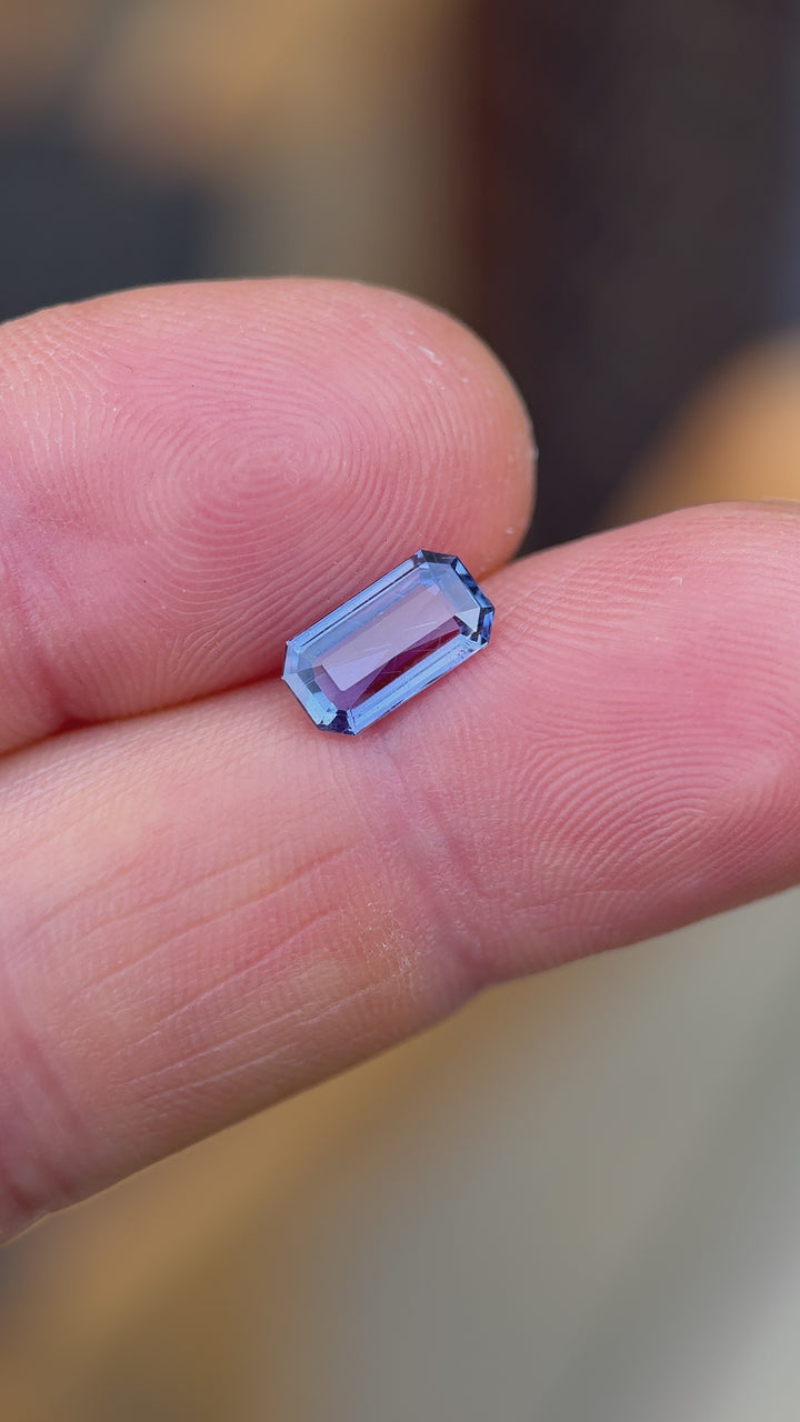 Rotating close-up video of 1.41ct violet-blue sapphire from Umba River, Tanzania in modified emerald cut showing clarity and color shifts