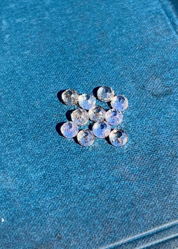 Video of antique Mughal cut diamonds rotating under light to reveal open culets, light blue fluorescence, and hand-cut facets in a 5.20 carat fancy light brown VVS diamond parcel from South Africa