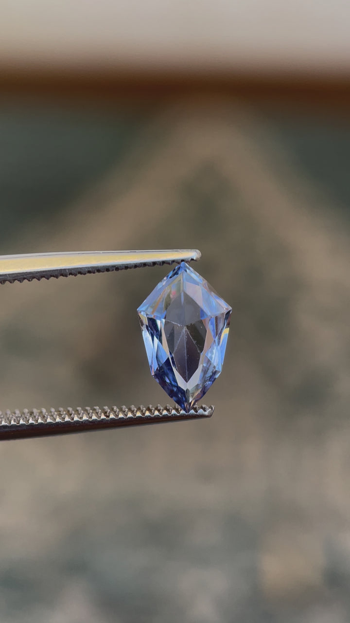Video showcasing Light Ceylon Denim Blue Sapphire, Custom Mix Shield Cut, 1.66 Carats, 11.12 x 6.95 x 3.20 mm, Originating from Sri Lanka, No Heat Treatment, $1328.00 Price