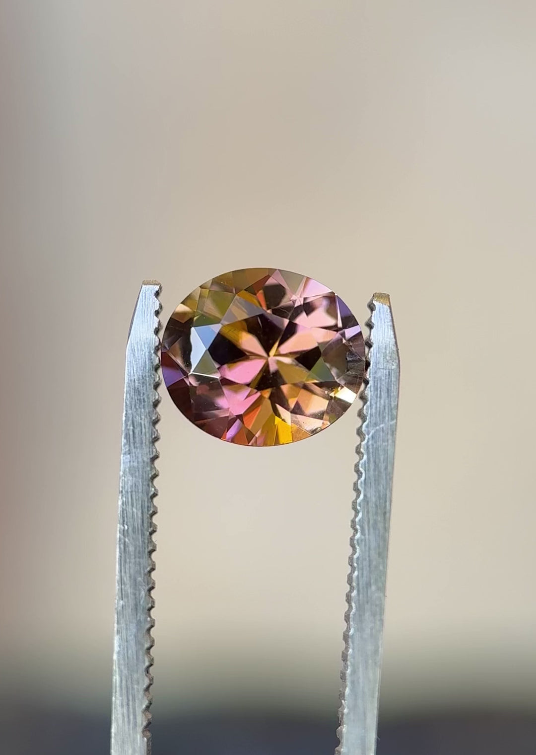 360-degree video of 2.76-carat Tanzanite in custom roval brilliant cut, highlighting orangish peach pink and purple sparkle in natural light
