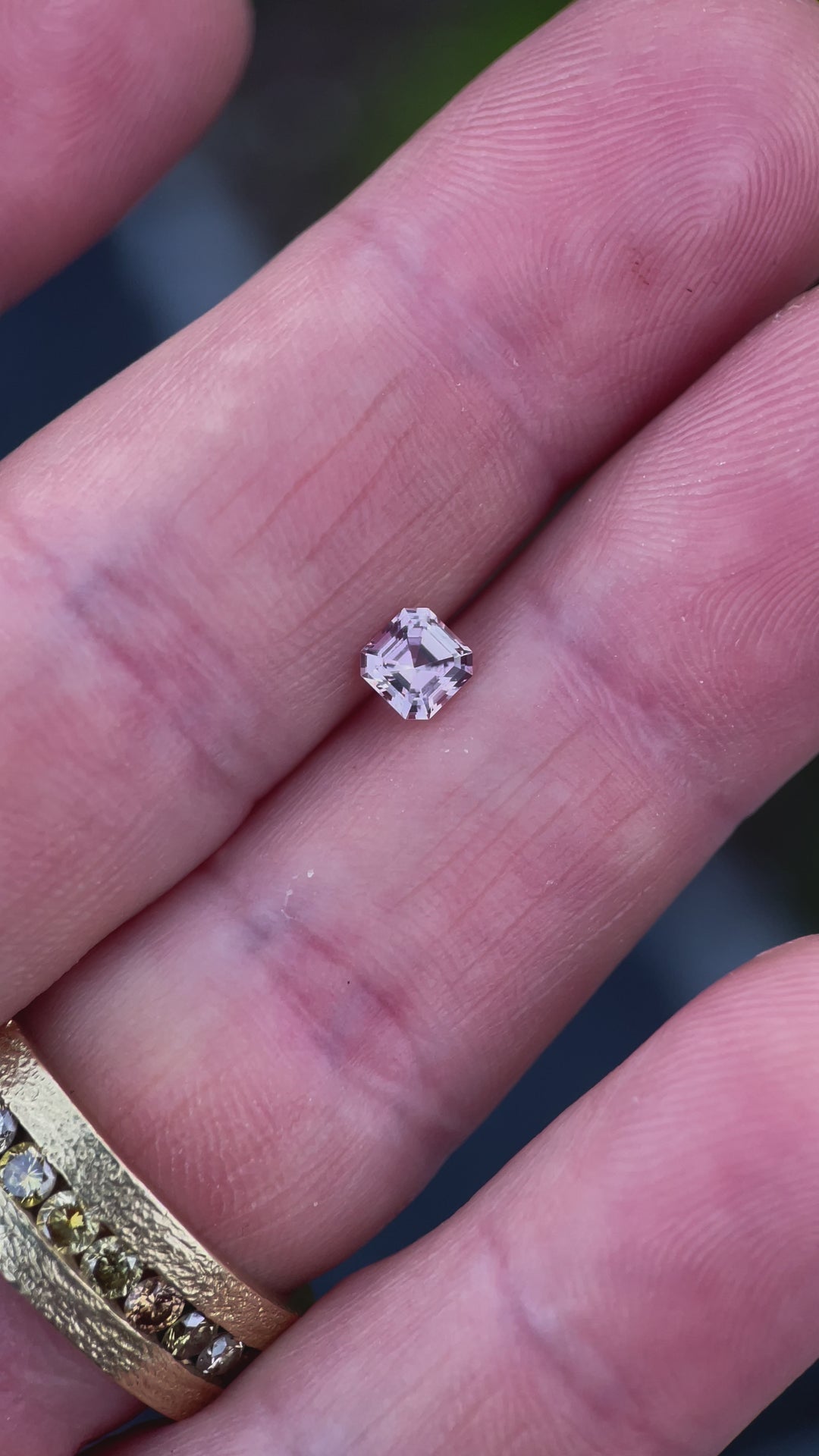 A 360-degree video showcasing the color-changing Montana sapphire as it shifts from peach pink to vibrant strawberry pink under different lighting conditions.