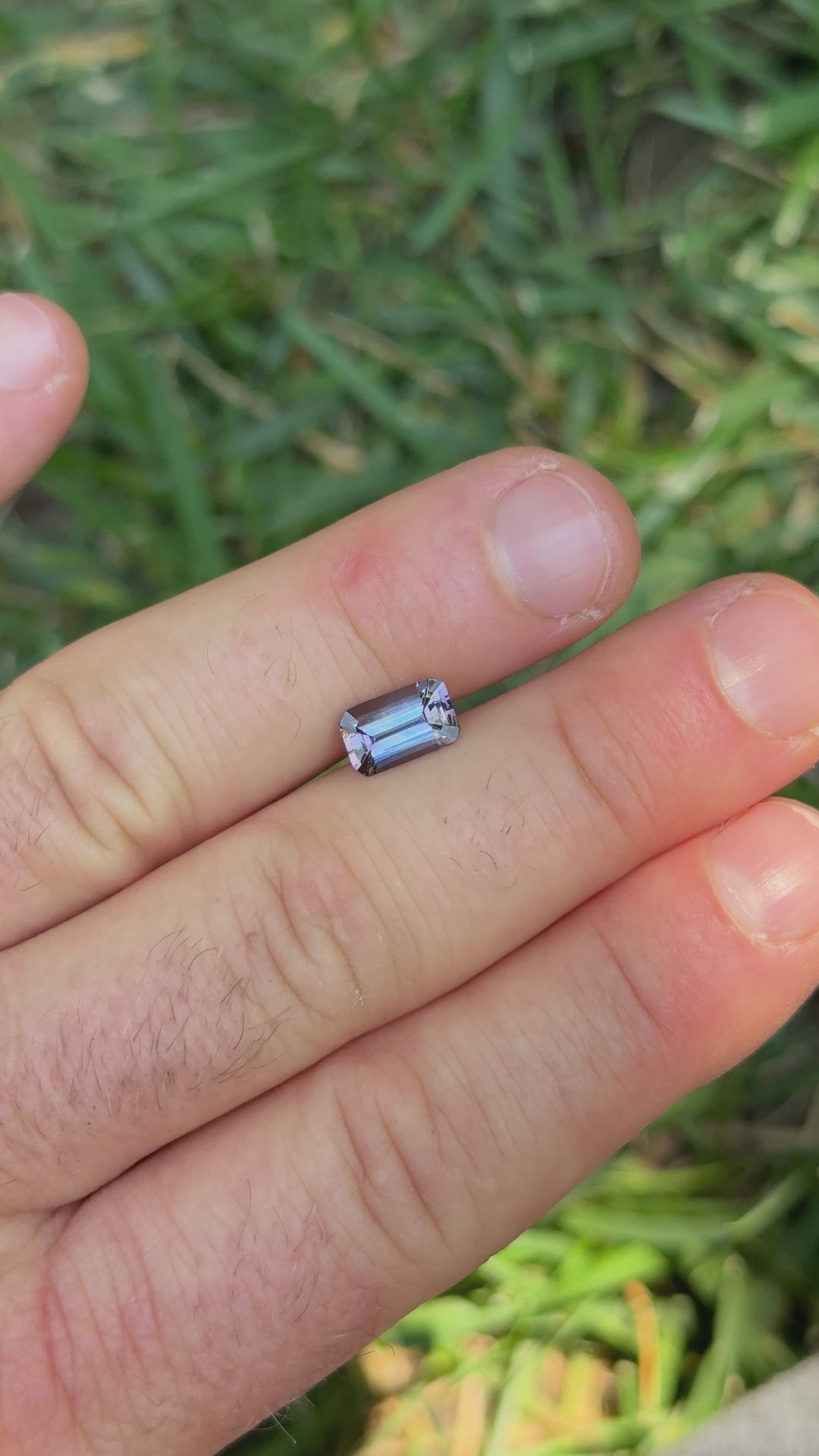 Rotating video of untreated Tanzanite highlighting its clean step-cut facets and vivid mermaid color palette