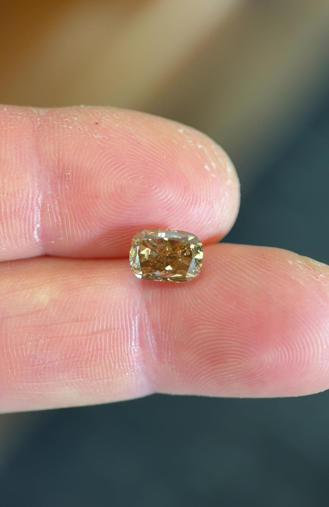 UV fluorescence video of a 2.20 carat fancy brown elongated cushion cut diamond from Argyle Mines, Australia, glowing with strong blue fluorescence. The untreated gem highlights its natural Argyle origin and distinct brown tones.