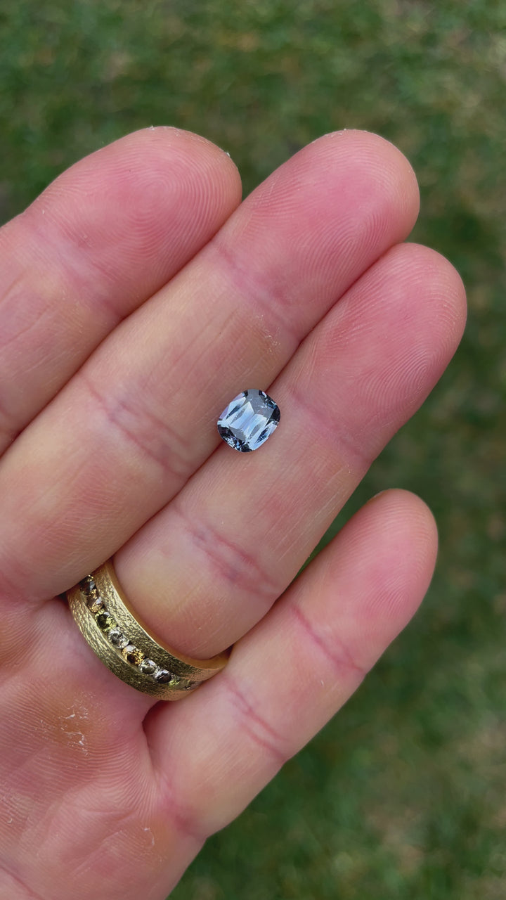 Detailed examination of a 1.48-carat modified cushion-cut sapphire with denim blue and cornflower tones, showcasing its untreated clarity and Sri Lankan origin.