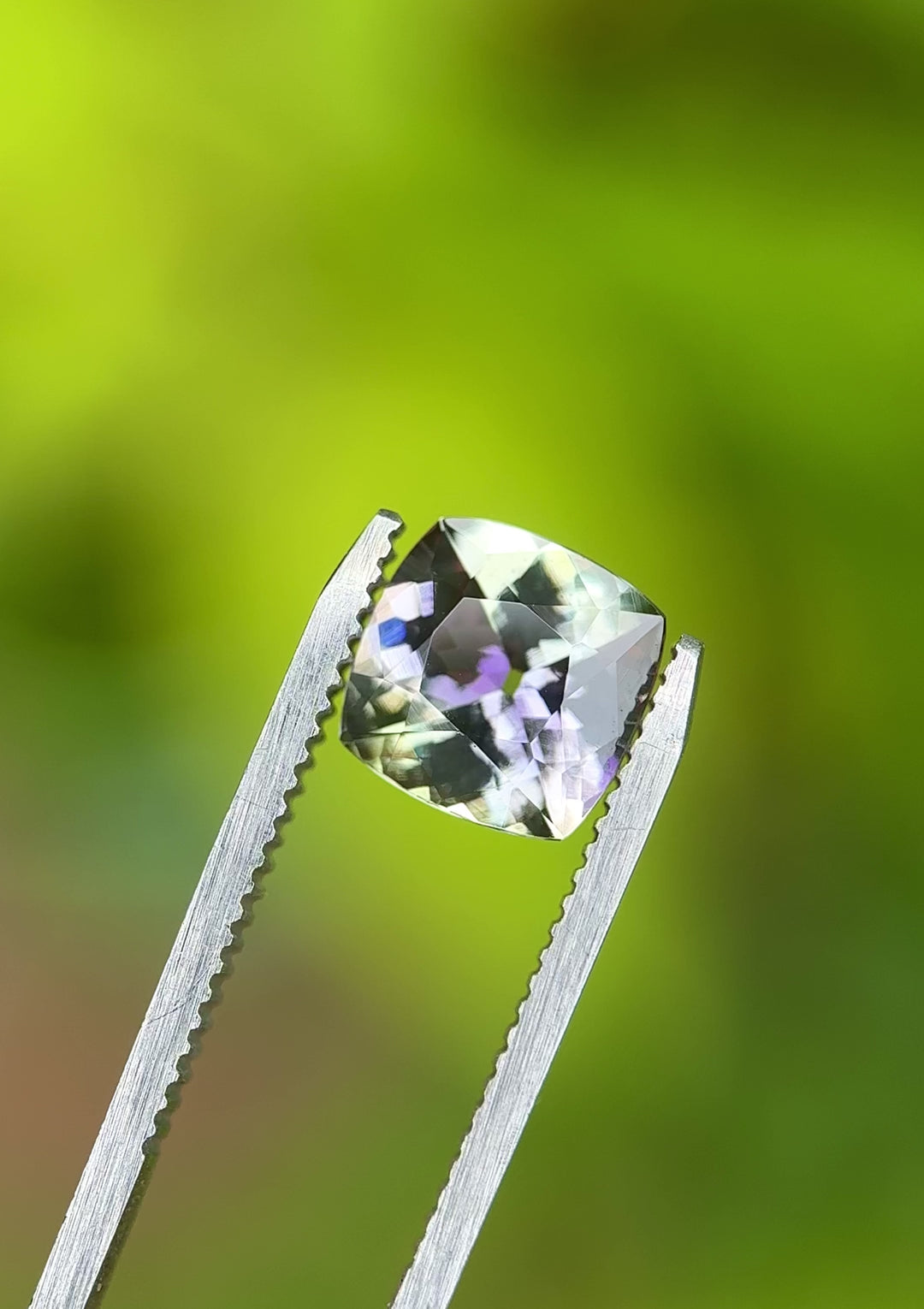 Video of 3.13ct cushion cut Tanzanite with shifting green and purple tones, rotating in natural light – untreated Tanzanian gemstone