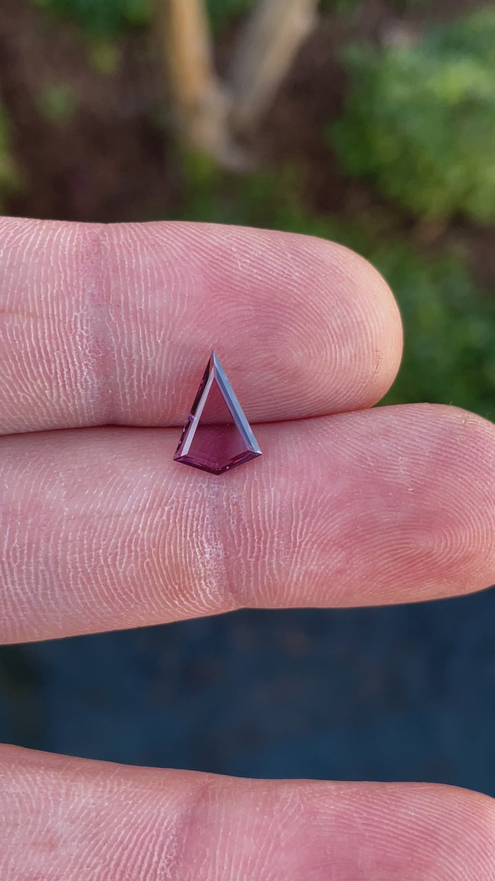 Video showcasing a 1.44 carat Sri Lankan spinel gemstone, custom kite portrait step cut, with purple and pink opalescent tones.