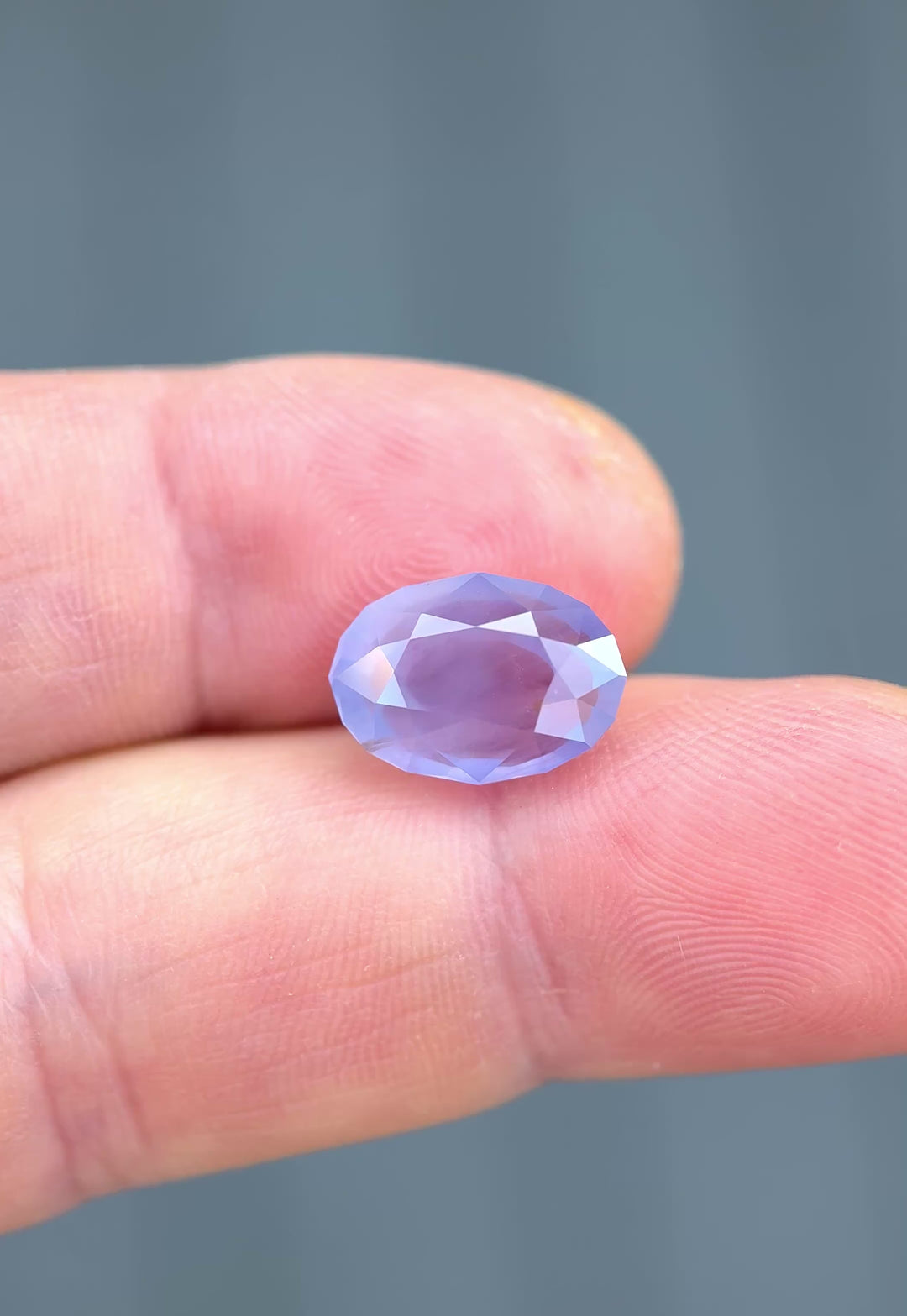 Sri Lankan sapphire with open culet moving in natural light showing internal silk and color shift.