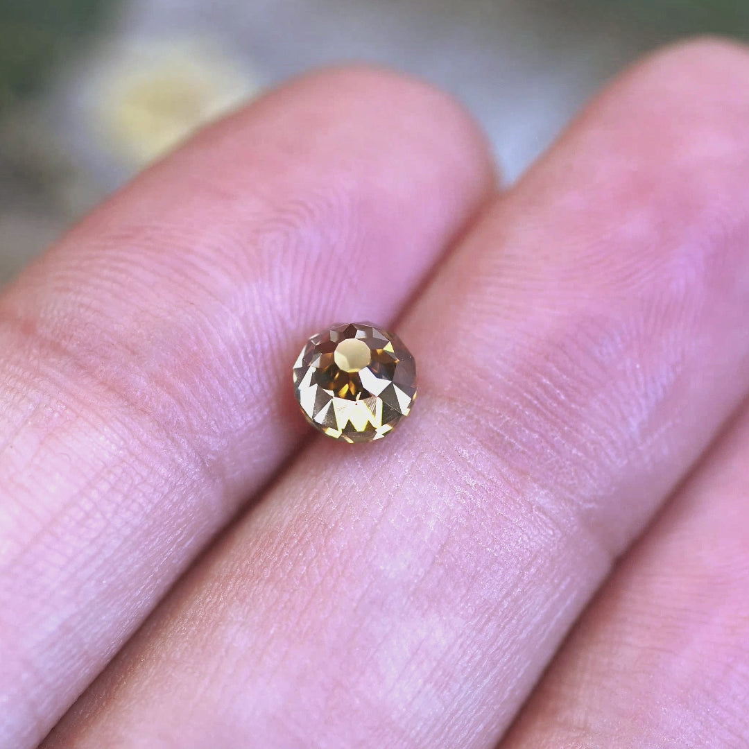 Rotating loose 1.14 carat fancy yellow brown Mughal cut diamond from South Africa, showing its antique faceting, champagne tone, and strong blue fluorescence.