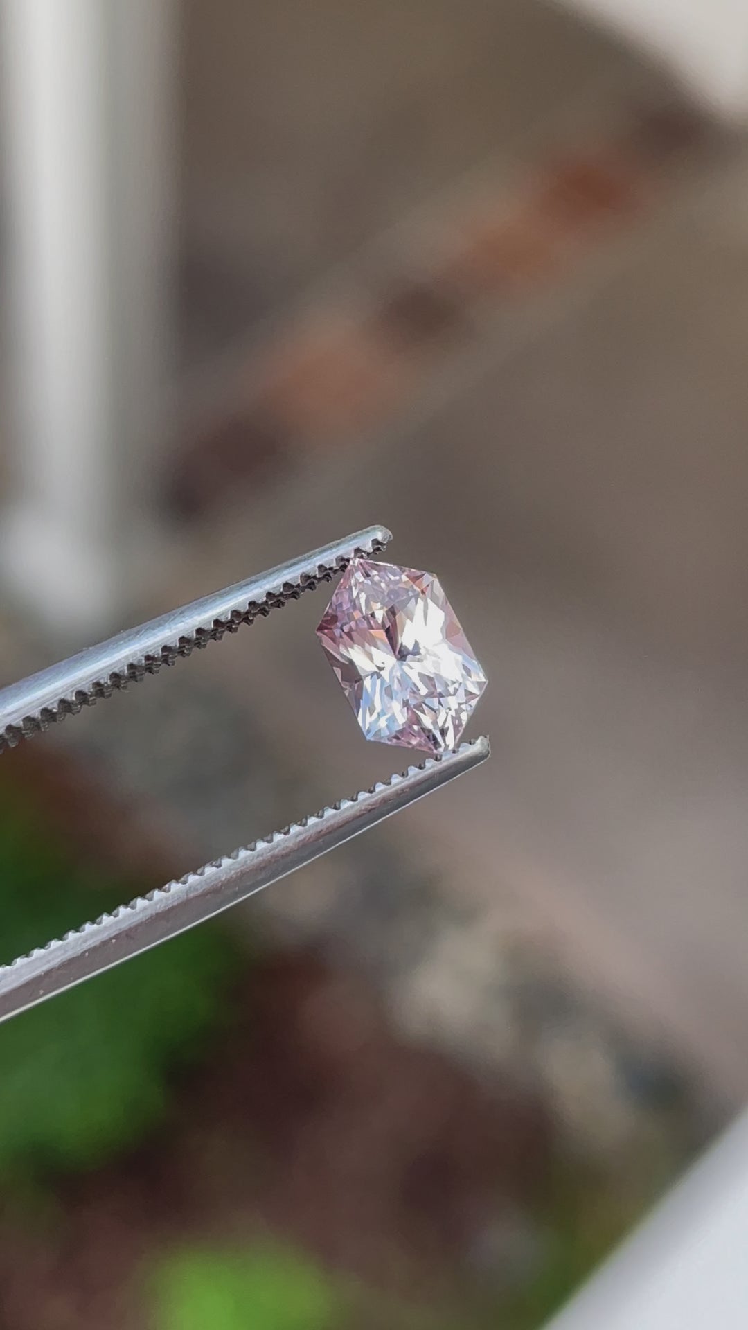 Video showcasing a 1.20 carat sapphire gemstone, hexagonal mixed cut with vibrant peach and pink tones, untreated and of Sri Lankan origin.