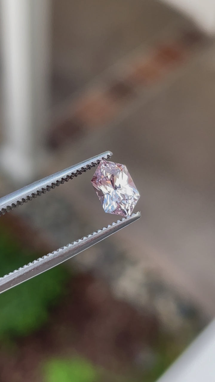 Video showcasing a 1.20 carat sapphire gemstone, hexagonal mixed cut with vibrant peach and pink tones, untreated and of Sri Lankan origin.