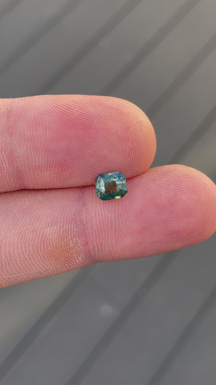 A video capturing the vibrant color play of a 1.42-carat sapphire with opalescent yellow, teal, and green tones. The radiant-cut gem is untreated and ethically sourced from Madagascar.
