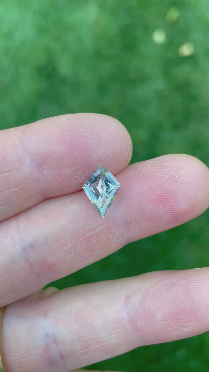 A 2.28-carat geometric modified step cut kite sapphire, displaying a vibrant seafoam green color, ethically sourced from Sri Lanka and untreated for natural luster.