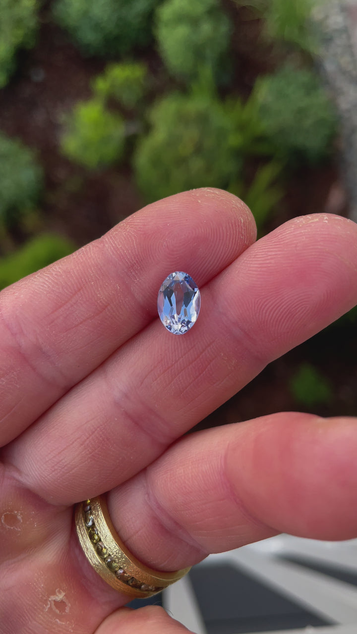 A dynamic video showcasing the luster and precise facets of a 2.50-carat cornflower blue sapphire as it catches the light in natural motion.