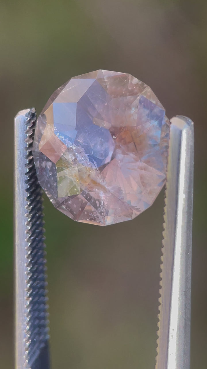 A close-up video of a 6.38-carat sapphire viewed in outdoor lighting, revealing its captivating green, gray, and yellow tones. Ethically sourced from Tanzania with no treatments applied.