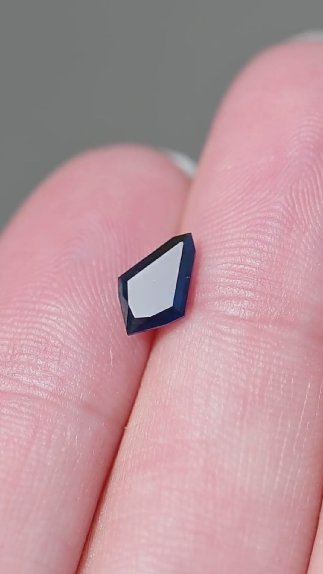See the scale, angular silhouette and deep blue color of this untreated 1.21ct step cut kite sapphire from the Central Queensland Gemfields, Australia.