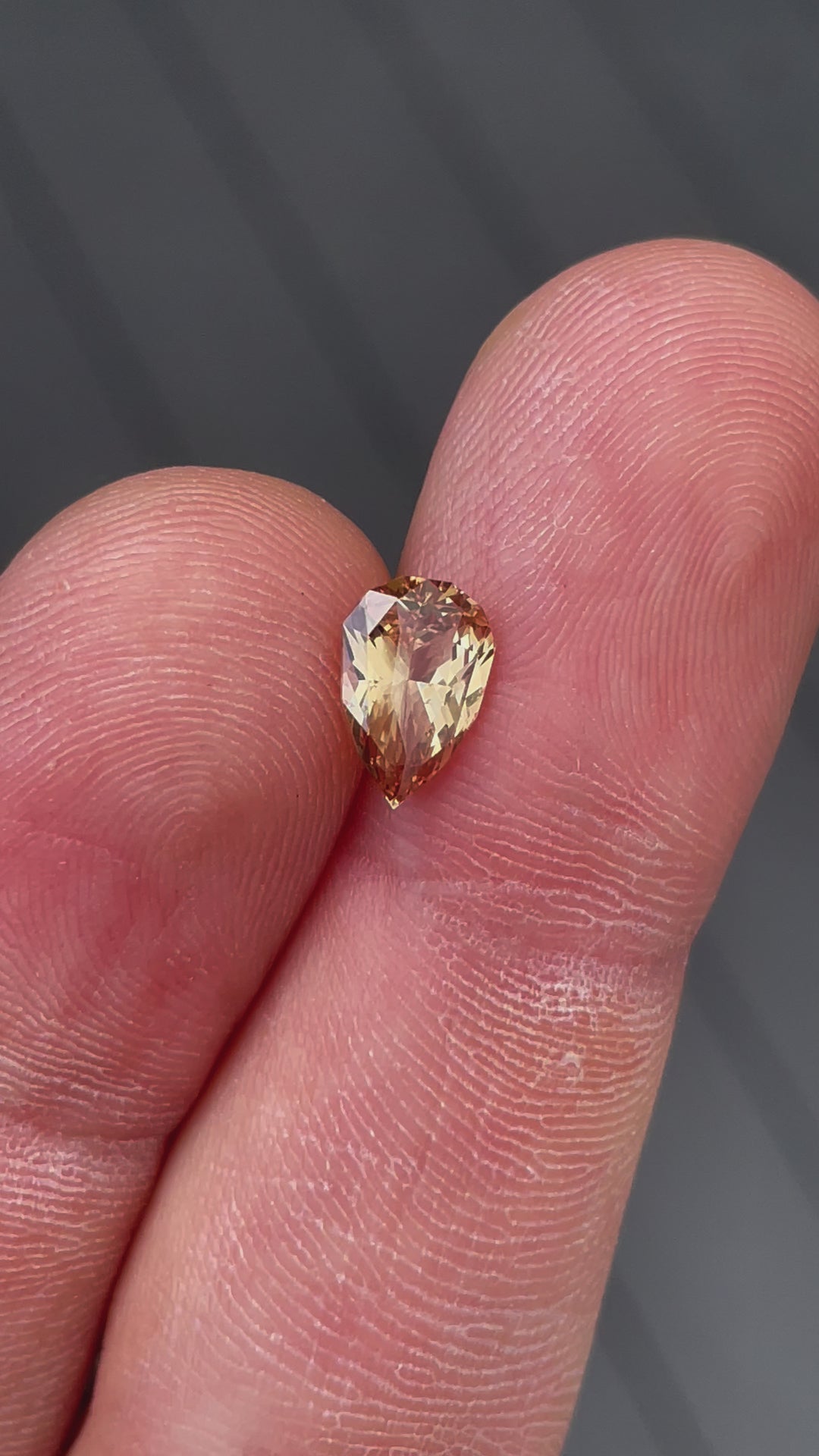 Detailed video of a 2.04-carat mix brilliant pear-cut sapphire, highlighting its untreated natural beauty and captivating yellow-brown tones.