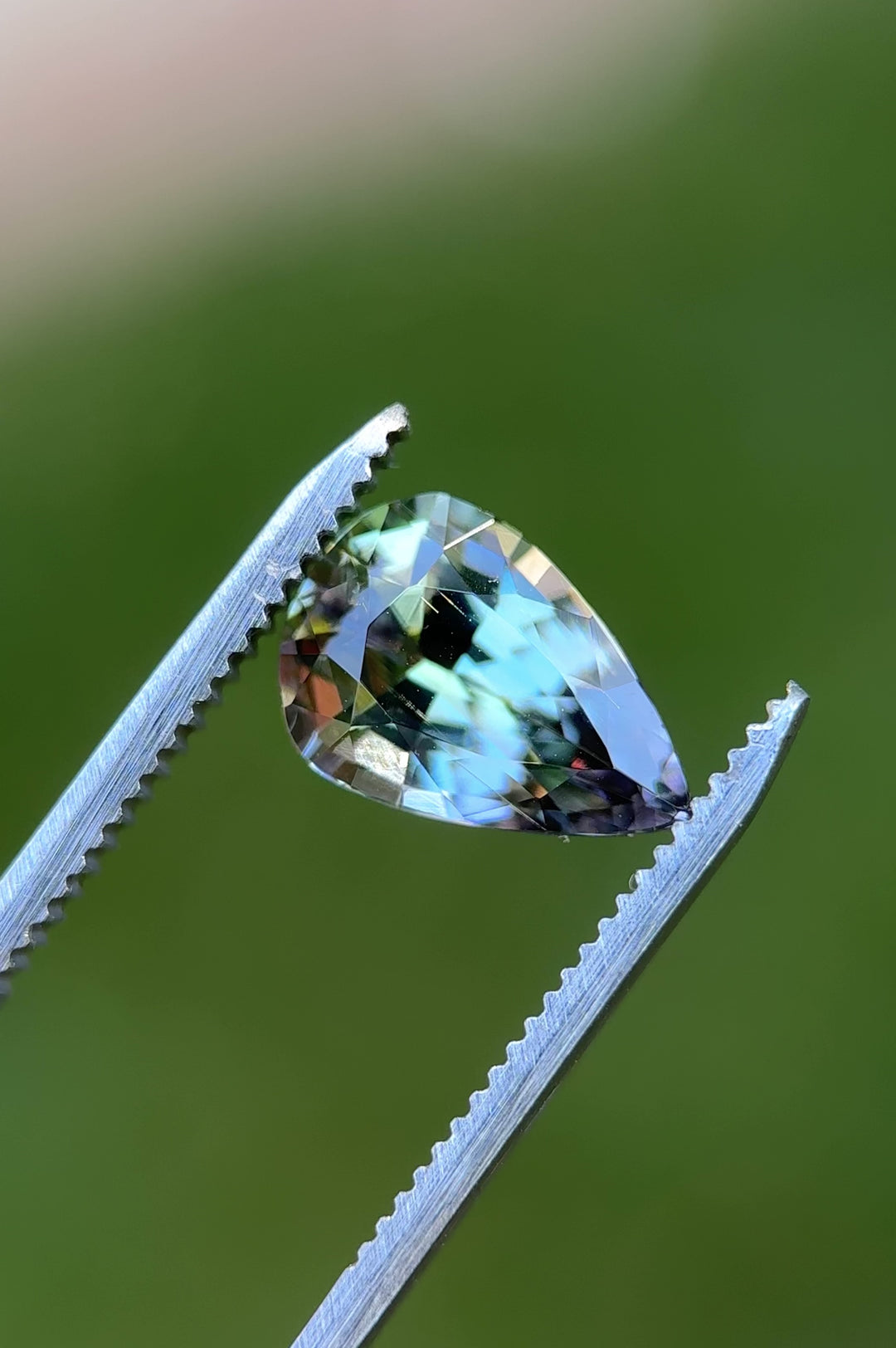 360-degree macro video of untreated Tanzanite from Tanzania, highlighting color shift from teal to peach and purple