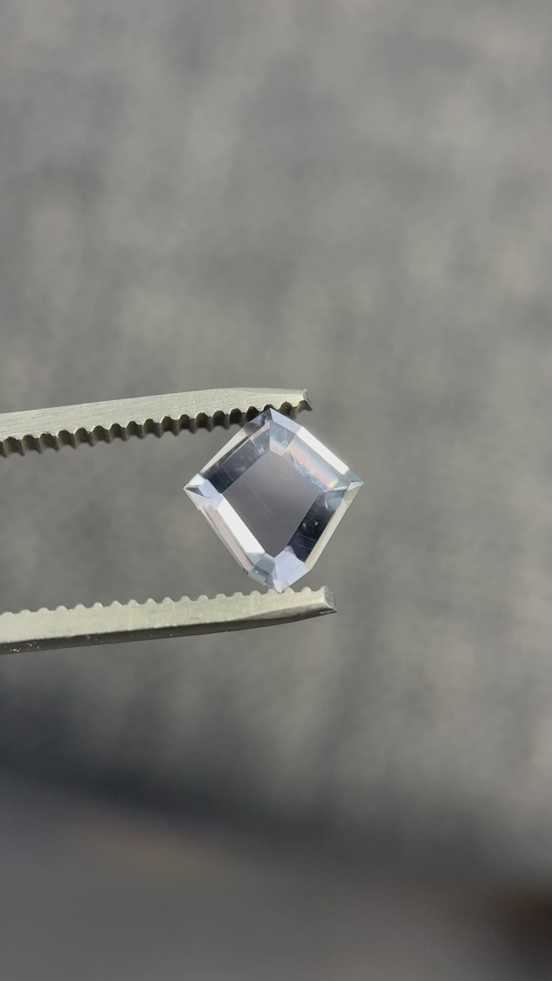 Close-up video of 1.52ct shield portrait cut sapphire showing dramatic color change and precision faceting.