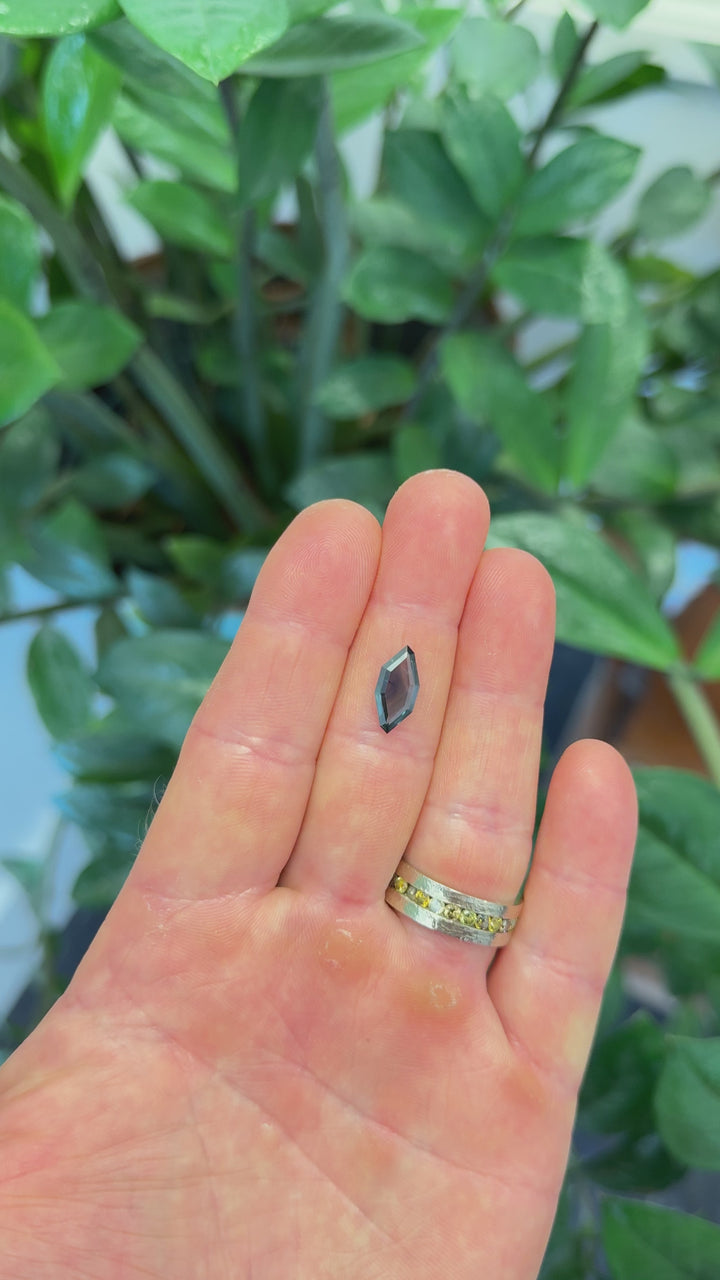 Close-up video of 2.00ct sapphire cut in an abstract portrait style, showcasing vivid blue undertones.