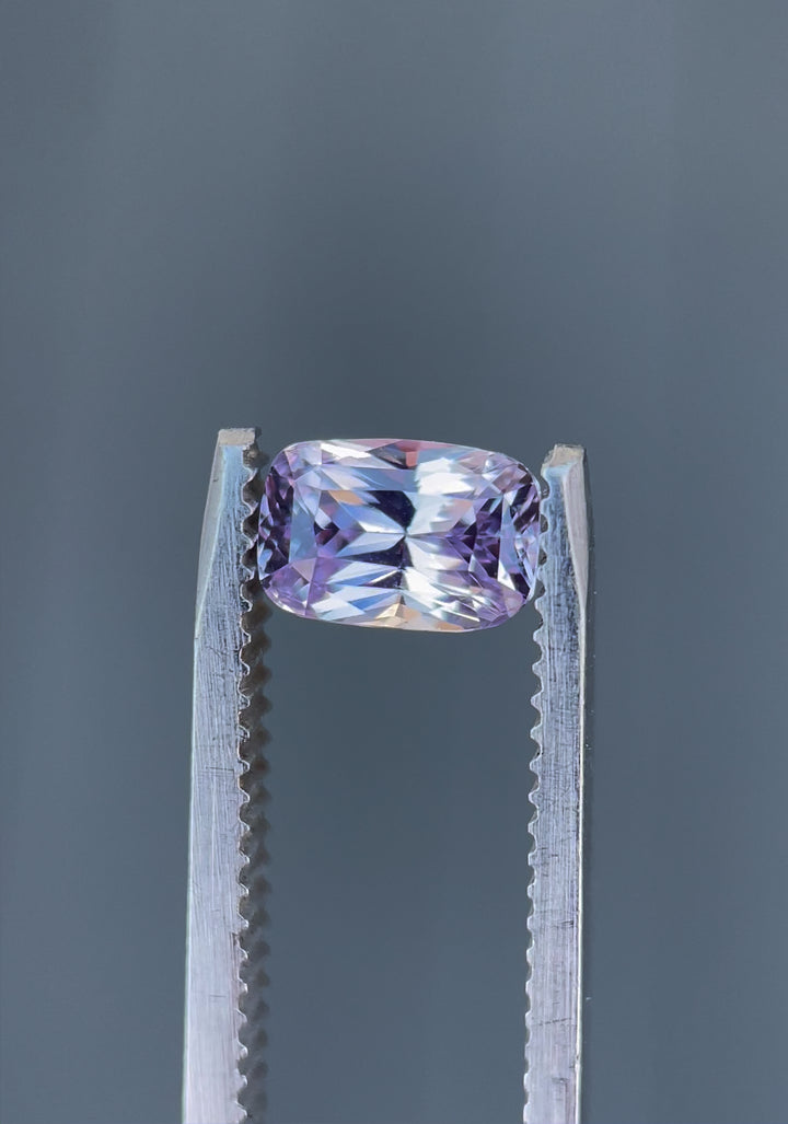 Close-up rotating view of a 1.57-carat pastel pink and purple sapphire with a rectangular cushion brilliant mixed cut, ethically sourced from Sri Lanka.