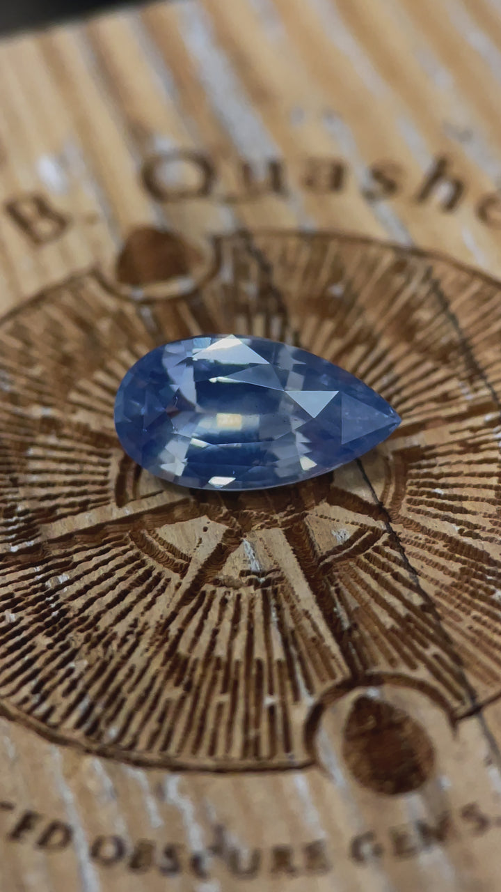 A dynamic video highlighting the brilliance and opalescent glow of a 3.53-carat sapphire with a pear mix brilliant cut, ethically mined from Sri Lanka.