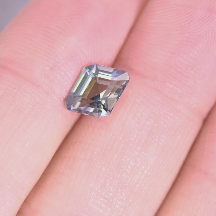 Close up video of 1.52ct Tanzanite rhombus step cut displaying geometric faceting brilliance and multicolor teal blue green purple tones