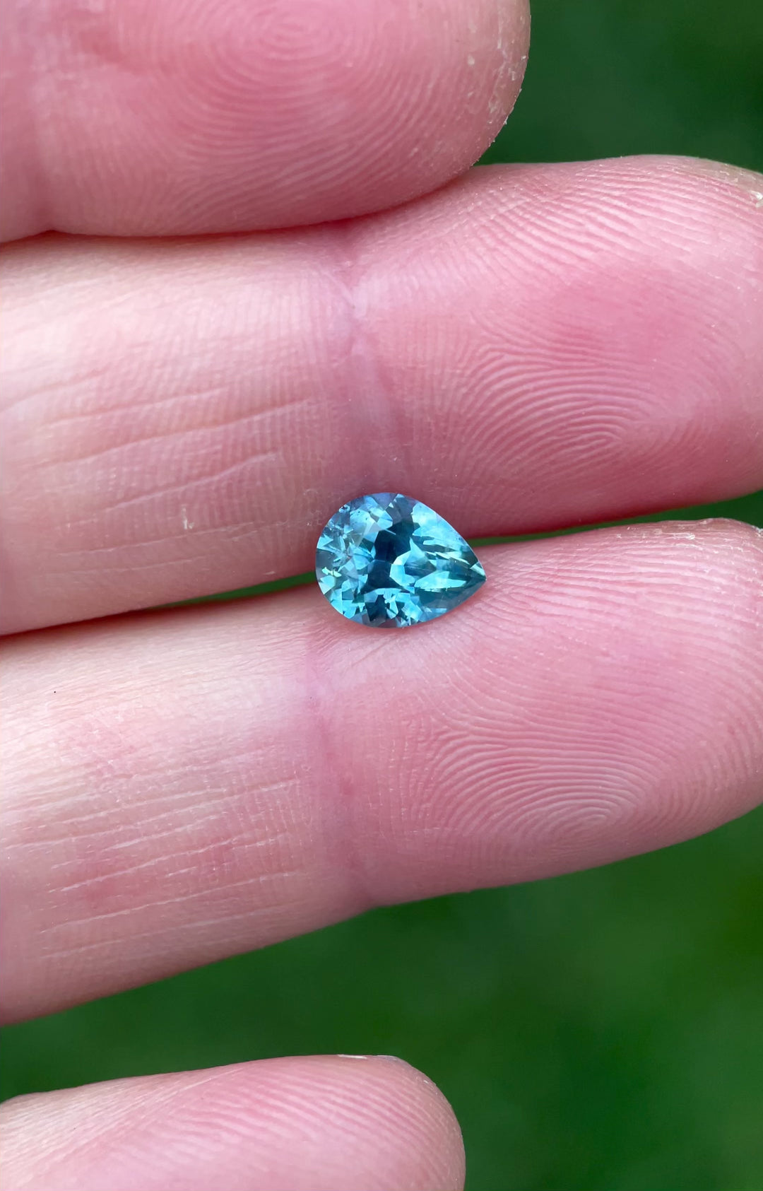 Rotating video of a 1.70ct heated blue sapphire, capturing its bright sparkle and vibrant blue tones in a custom pear brilliant cut.
