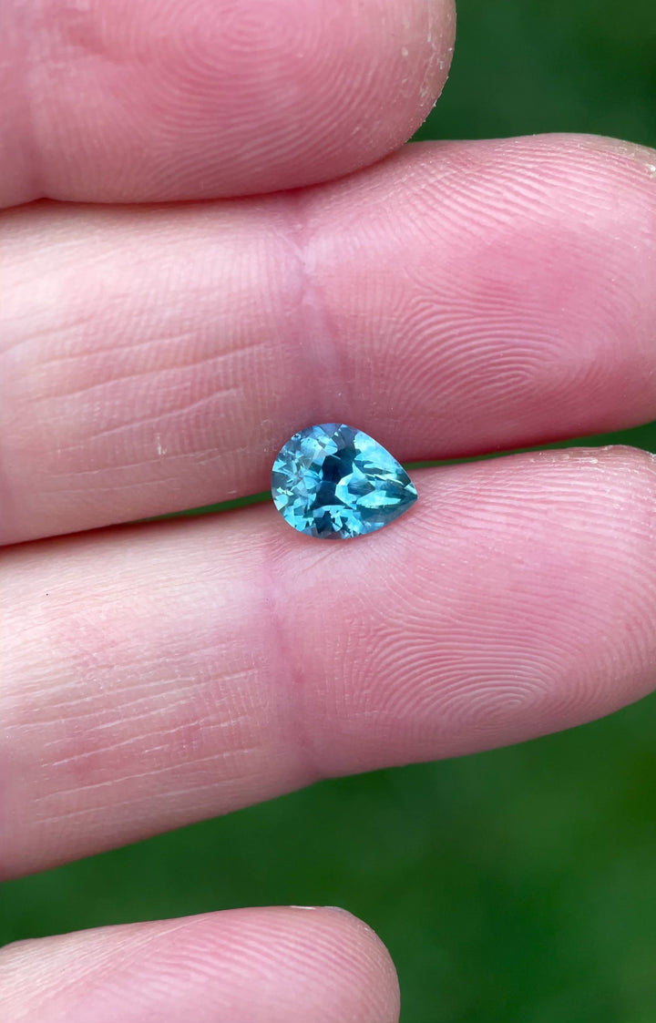 Rotating video of a 1.70ct heated blue sapphire, capturing its bright sparkle and vibrant blue tones in a custom pear brilliant cut.