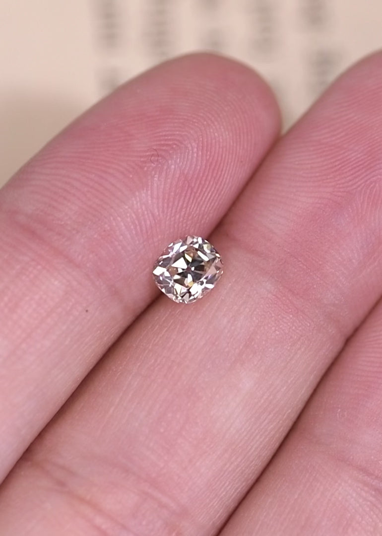 Rotating old mine cut cushion diamond showing chunky facets and soft antique brilliance.