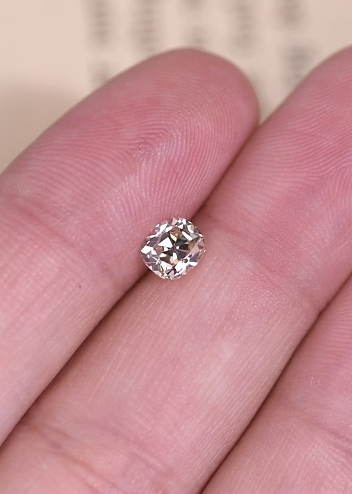 Rotating old mine cut cushion diamond showing chunky facets and soft antique brilliance.